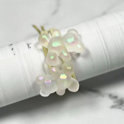 Pearl teddy hair ties with iridescent beads on gold elastic bands displayed on white background