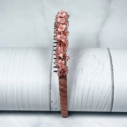 Pink embellished headbands for women with floral and bead details on a wrapped base