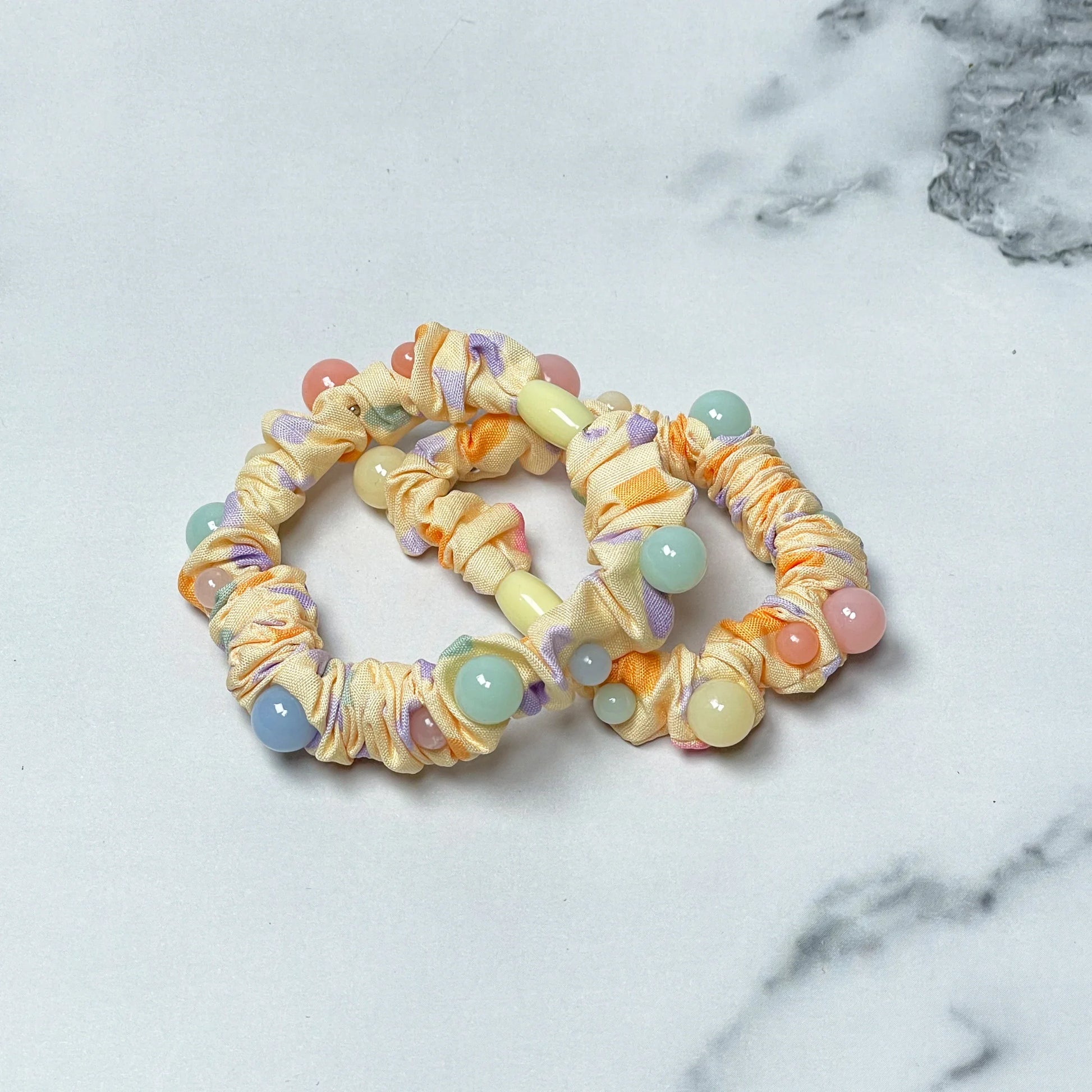 Colorful printed hair ties with beads on light fabric scrunchies for stylish hair accessories