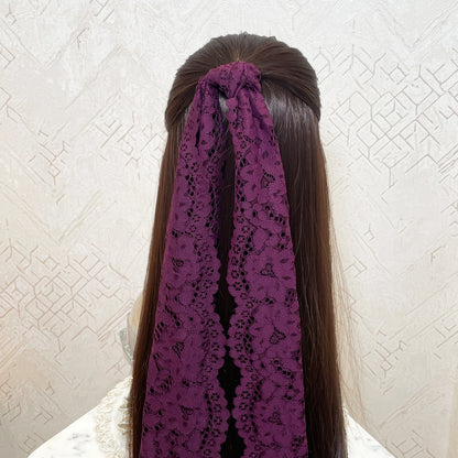Bella Luxe cherry lacy hair scarf in deep purple tied on long brown hair with intricate lace detailing
