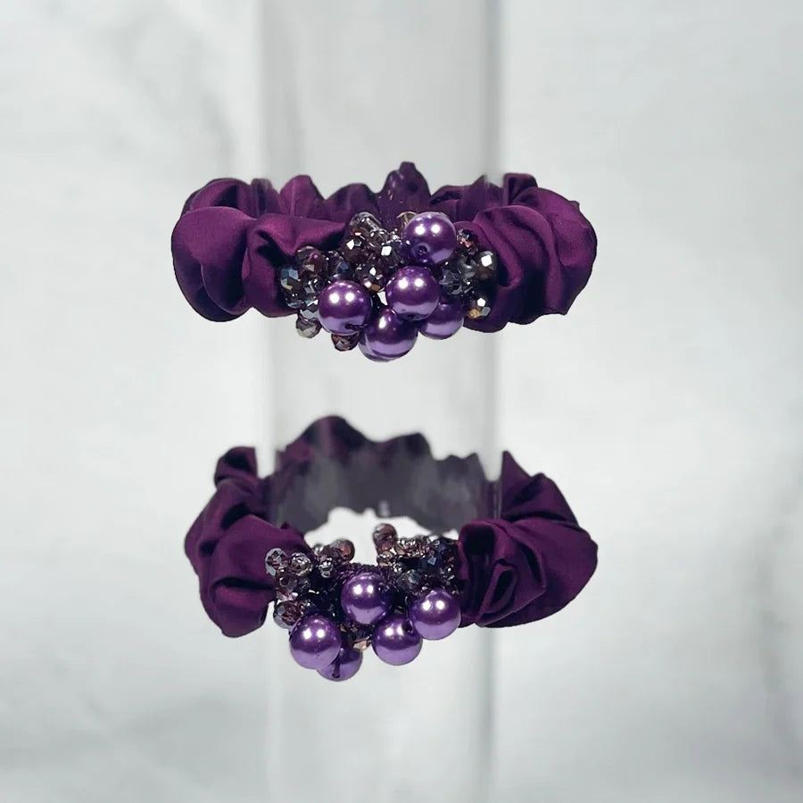 Purple fabric crystal studded hair ties with decorative purple beads and rhinestones for stylish hairstyles