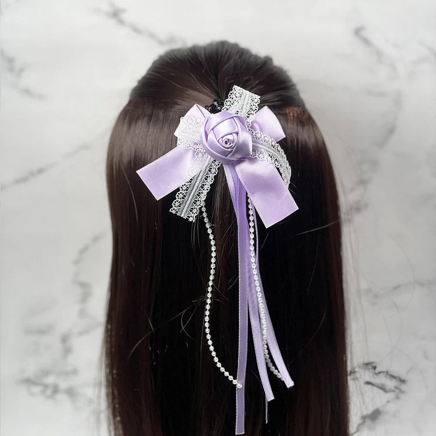 Lavender rose flower hairpins for kids with lace and pearl ribbon detail on dark brown hair