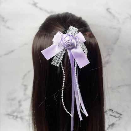 Lavender rose flower hairpins for kids with lace and pearl ribbon detail on dark brown hair