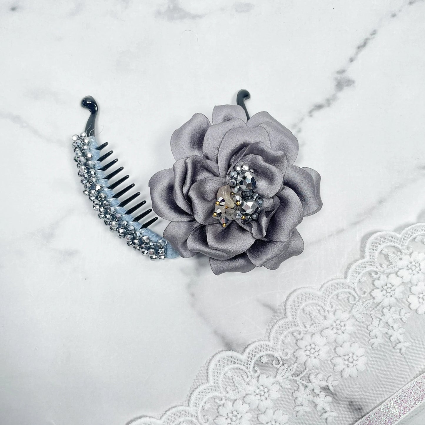 Bella Luxe silver crystal banana clip with a gray fabric flower and sparkling crystals