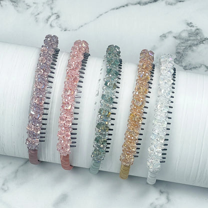 Set of five colorful studded headbands with crystal-like embellishments displayed on white surface