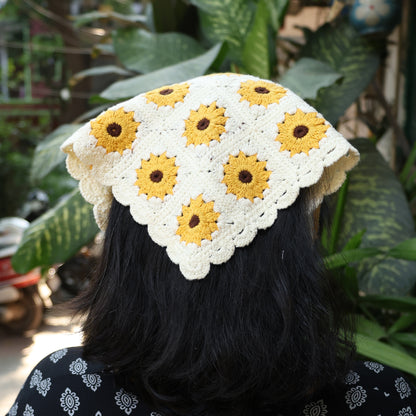 Sunflower crochet bandana in cream with yellow sunflowers worn on black hair outdoors