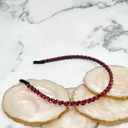 Red thin embellished headbands for women with sparkling details on a marble background