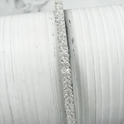 Elegant thin embellished headbands for women with clear floral crystal design on white background
