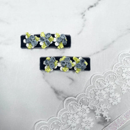 Set of velvet flower hair pins with blue velvet roses and yellow ribbon accents on black base
