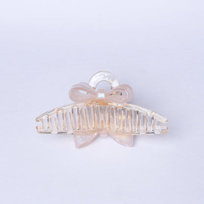 Transparent bow hair clutches with a delicate light pink bow detail for stylish hair styling