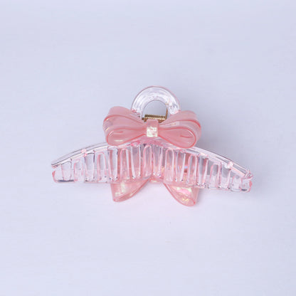 Pink bow hair clutches with clear plastic claw clip for stylish hair hold
