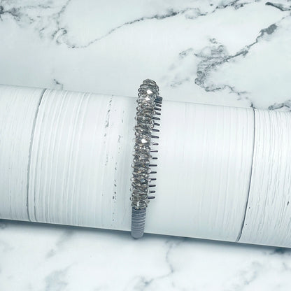Heavy Crystal Embellished Hairbands with sparkling crystals on a white textured display stand