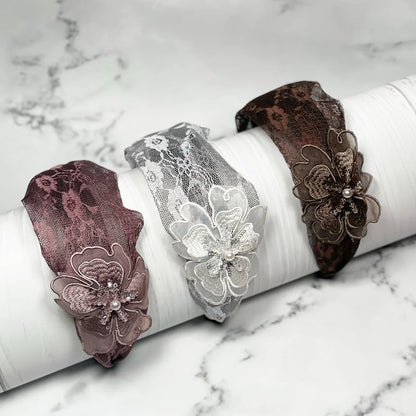 Set of lacy embellished hairbands for women in brown, white, and maroon with floral decorations