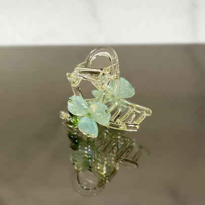 Clear hair clutch with pearl studded flower hair clutch design in soft blue petals and green centers