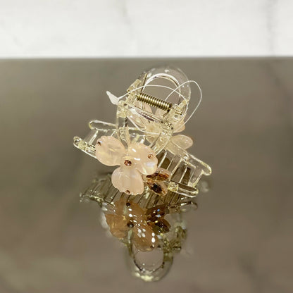 Clear plastic hair claw clip with delicate pearl studded flower hair clutch design