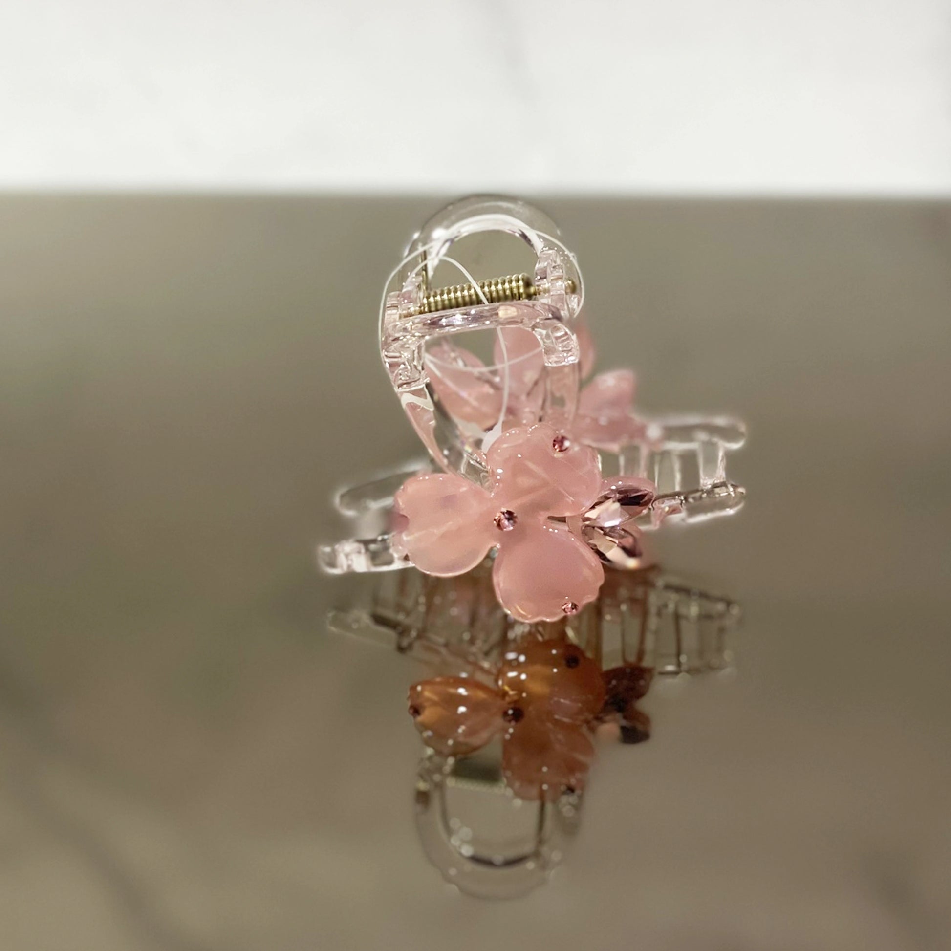 Pink pearl studded flower hair clutch with transparent claw design for stylish hair hold
