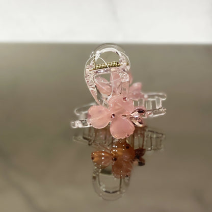 Pink pearl studded flower hair clutch with transparent claw design for stylish hair hold