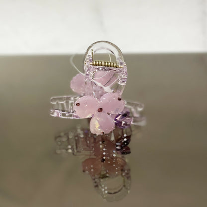 Clear hair clutch with pink pearl studded flower design for elegant hair styling