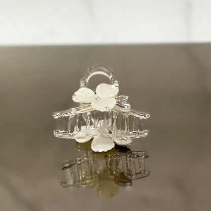 Clear plastic pearl studded flower hair clutch with delicate white petals and small pearl accents