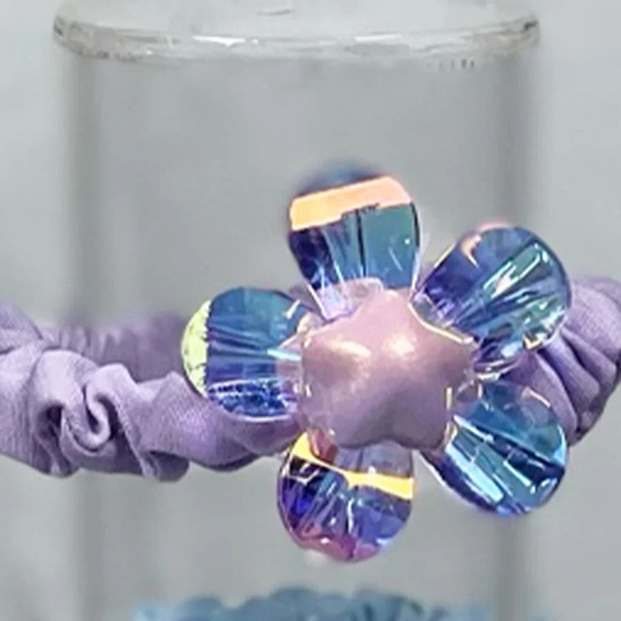 Purple shiny daisy flower hair ties with iridescent petals on elastic band
