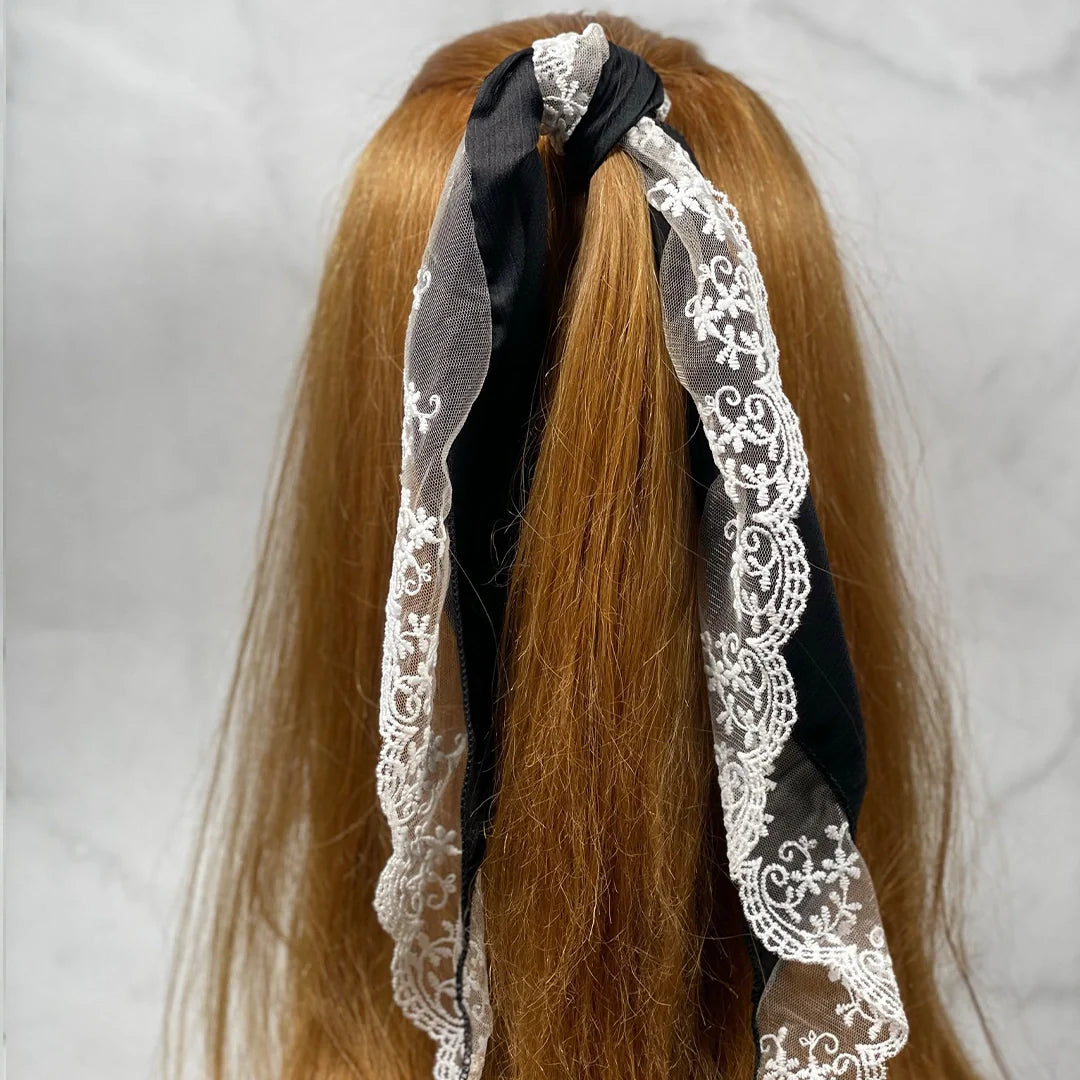 Synthetic Lacy Hair Scarf in black with white lace detail styled on long brown hair