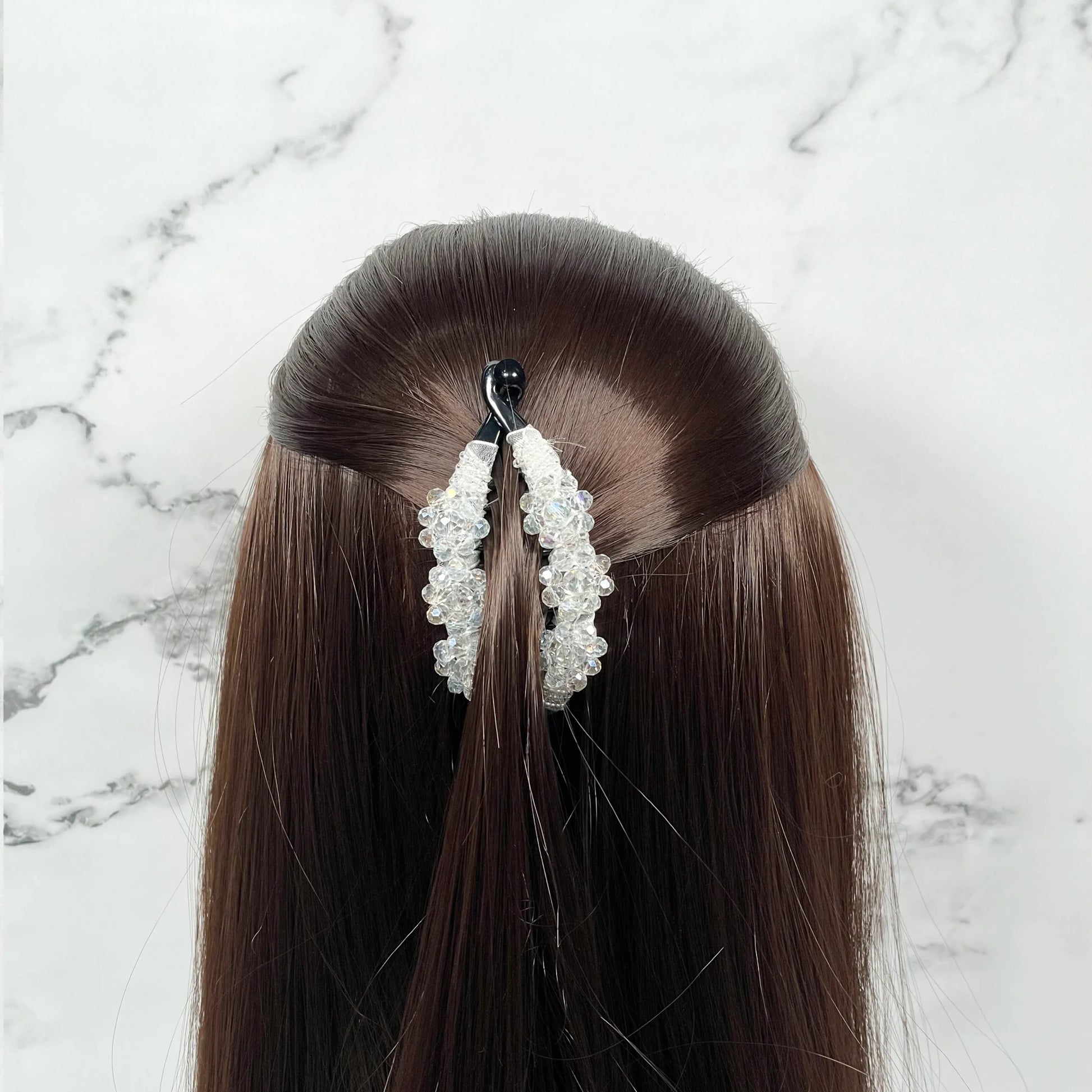 Bella Luxe white crystal studded banana clip securing half up hairstyle on brown hair