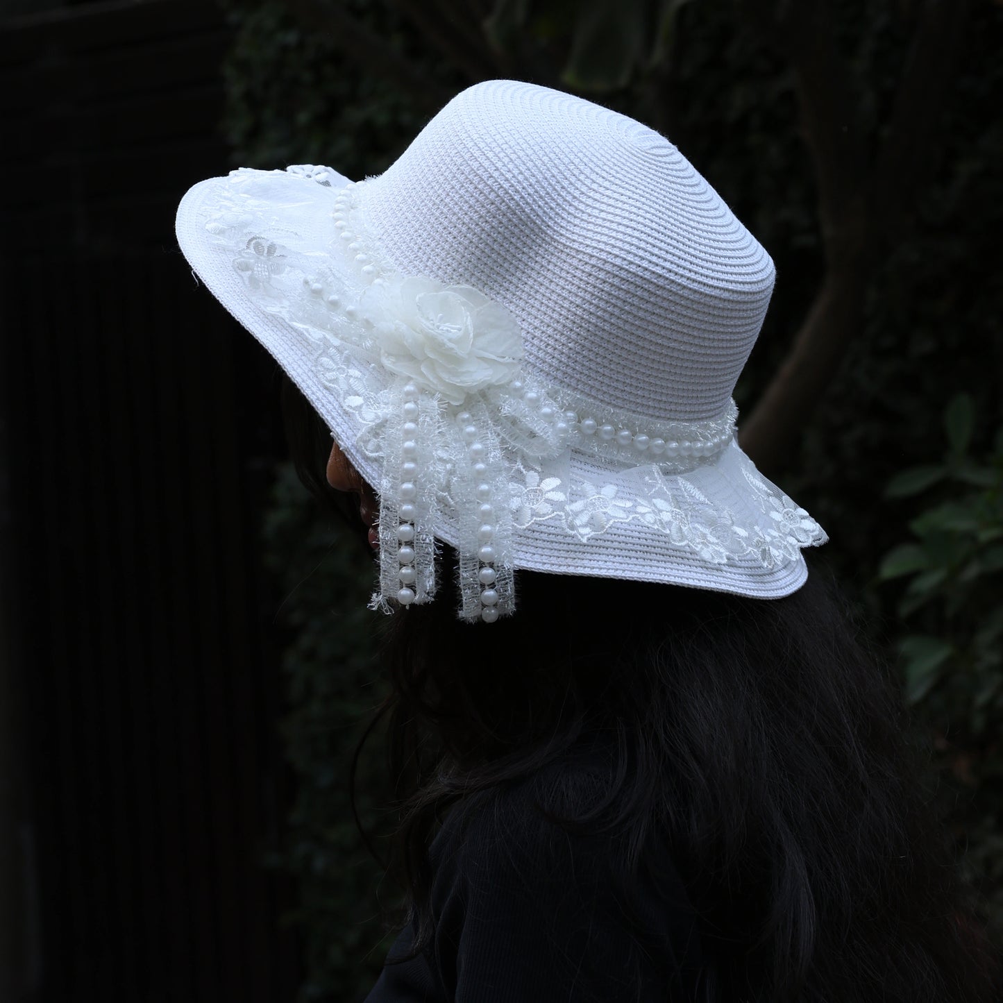 Bella Luxe white straw hat with pearl ribbon featuring floral lace and decorative bow