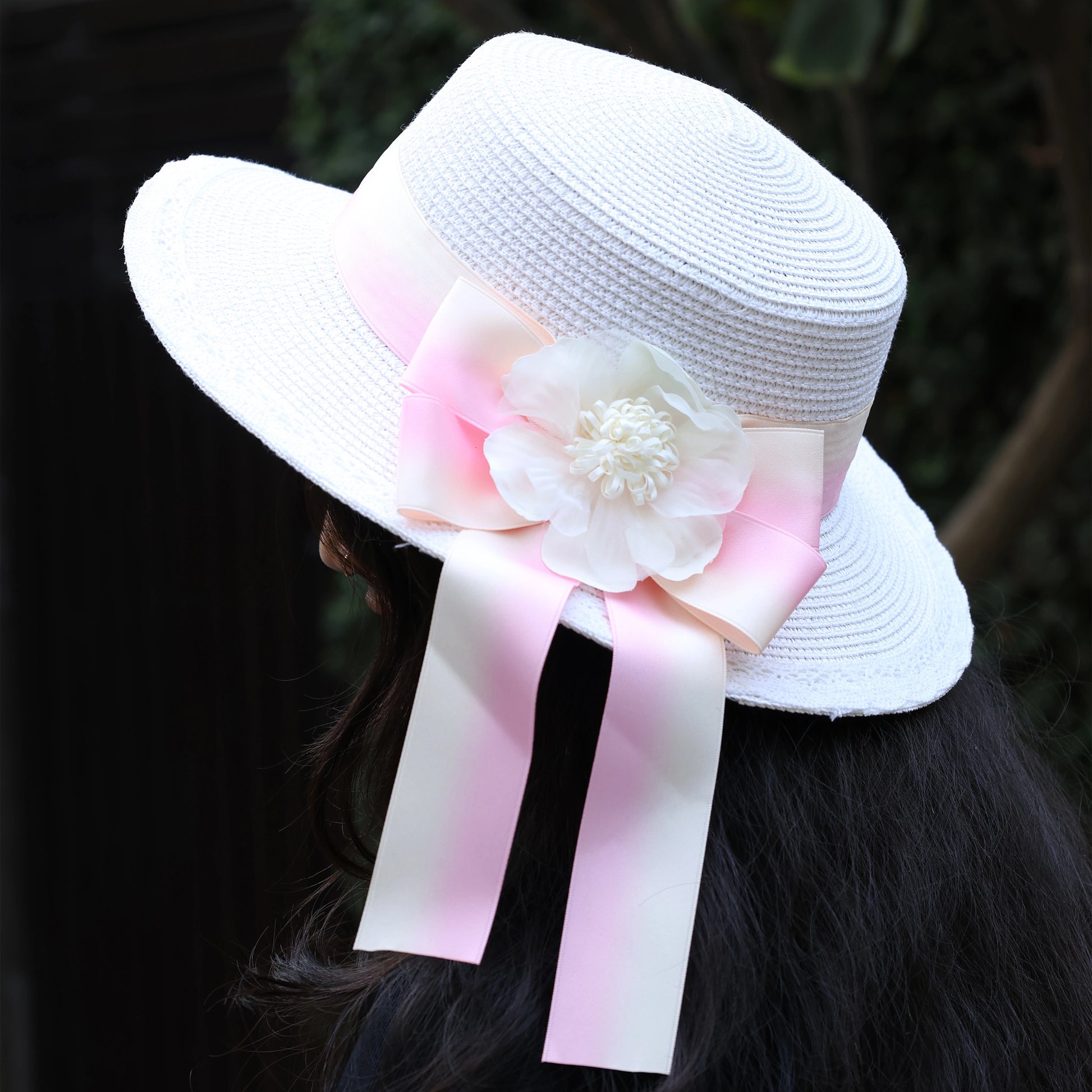 Bella Luxe white straw hat with pink ribbon and flower decoration on the back